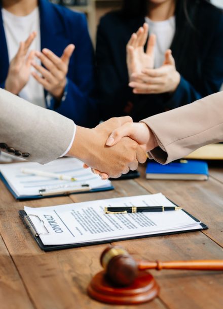 Business and lawyers discussing contract papers with brass scale on desk in office. Law, legal services, advice,  justice and law concept .