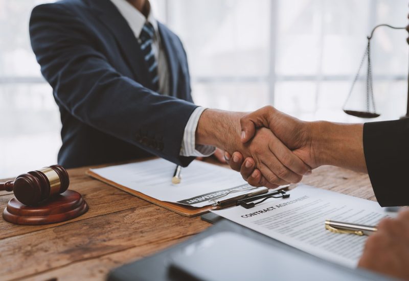 Lawyers join hands with business people to sign a partnership agreement on cooperation agreements related to joint financing of financial business. concept of justice, real estate