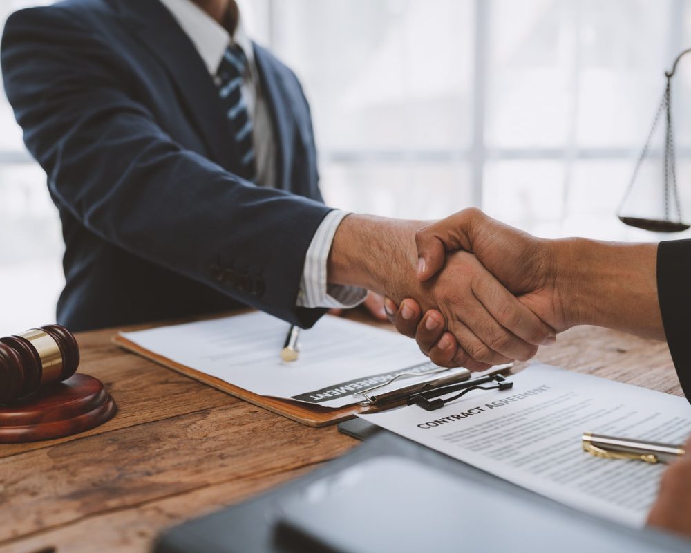 Lawyers join hands with business people to sign a partnership agreement on cooperation agreements related to joint financing of financial business. concept of justice, real estate